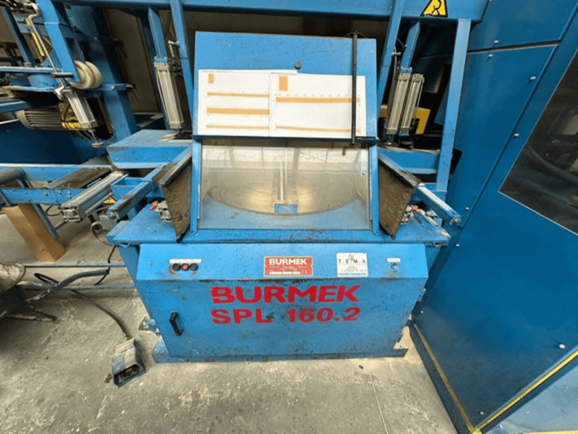 Синий станок по дереву BURMEK SPL 160.2, вид спереди, с кнопками управления и стеклянной панелью, демонстрирующей внутреннее устройство.