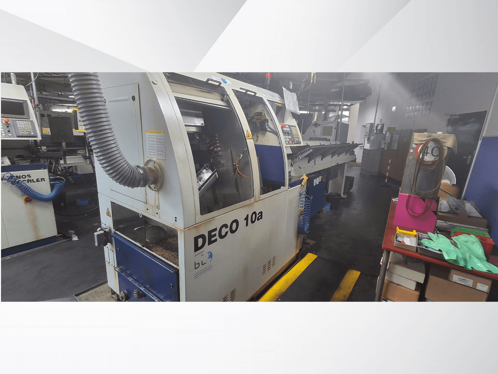 Станок с ЧПУ DECO 10a в мастерской, вид спереди; панель управления и система пылеудаления, рядом верстак.