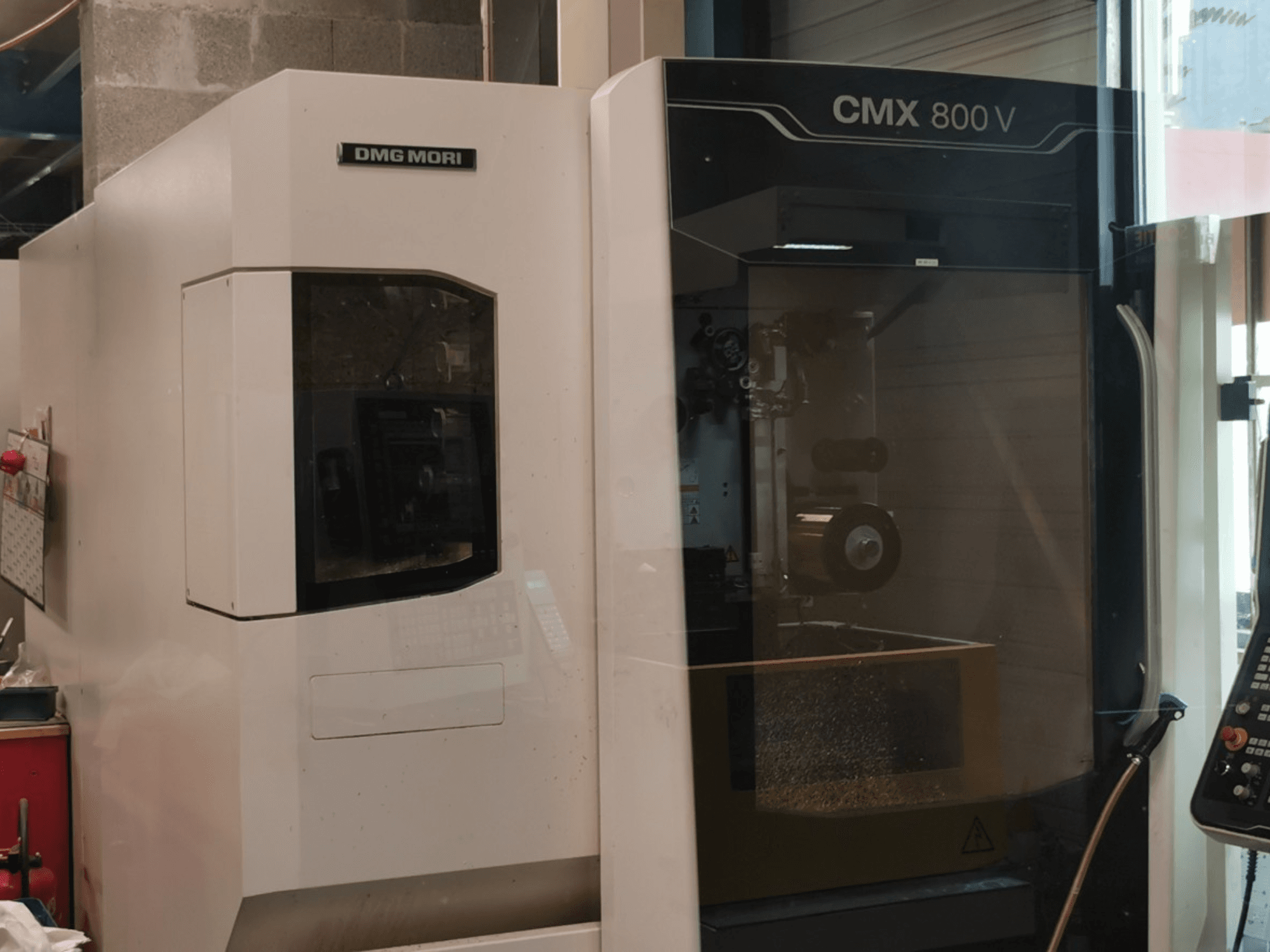 Вертикальный обрабатывающий центр DMG Mori Seiki CMX 800 V, вид спереди с панелью управления и рабочей зоной, на которой видны инструменты.