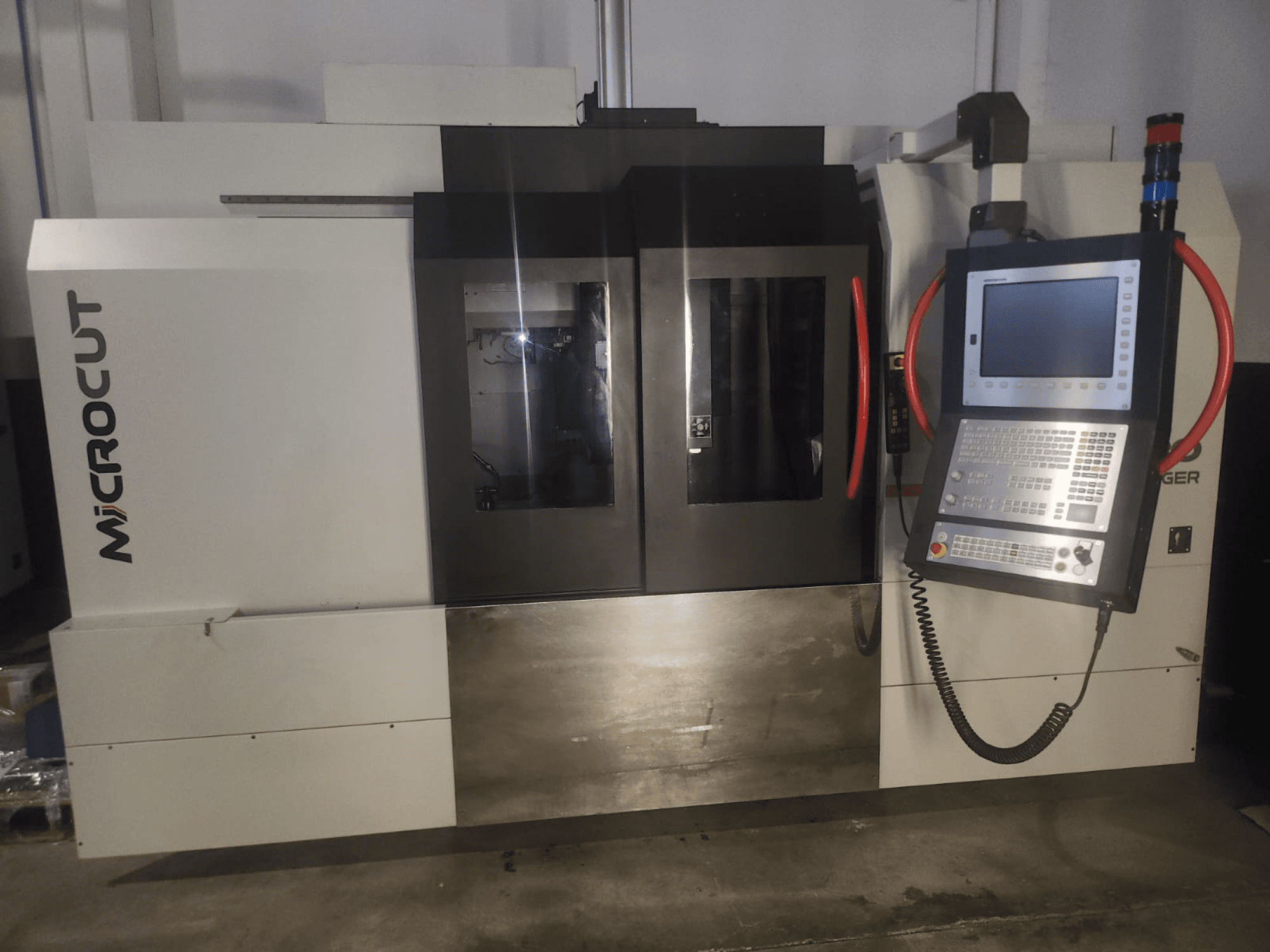 Станок с ЧПУ Microcut, вид спереди; панель управления, два окна, промышленный дизайн и металлическая отделка.