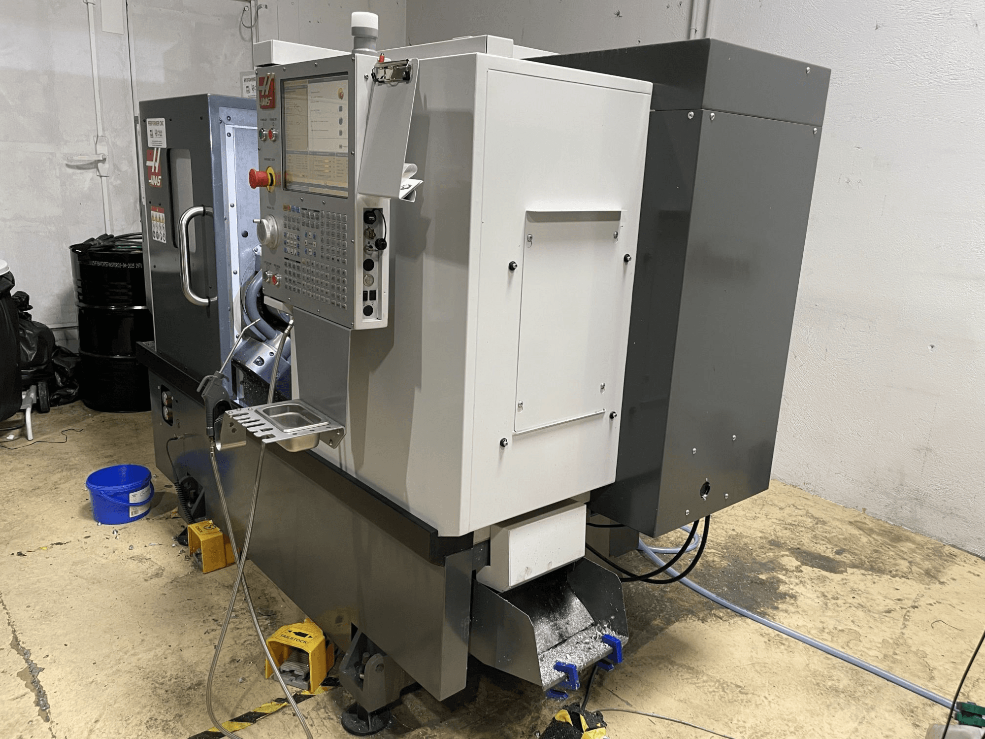 Горизонтальный токарный станок HAAS ST-15Y в цехе, отличающийся панелью управления и прочной промышленной конструкцией.
