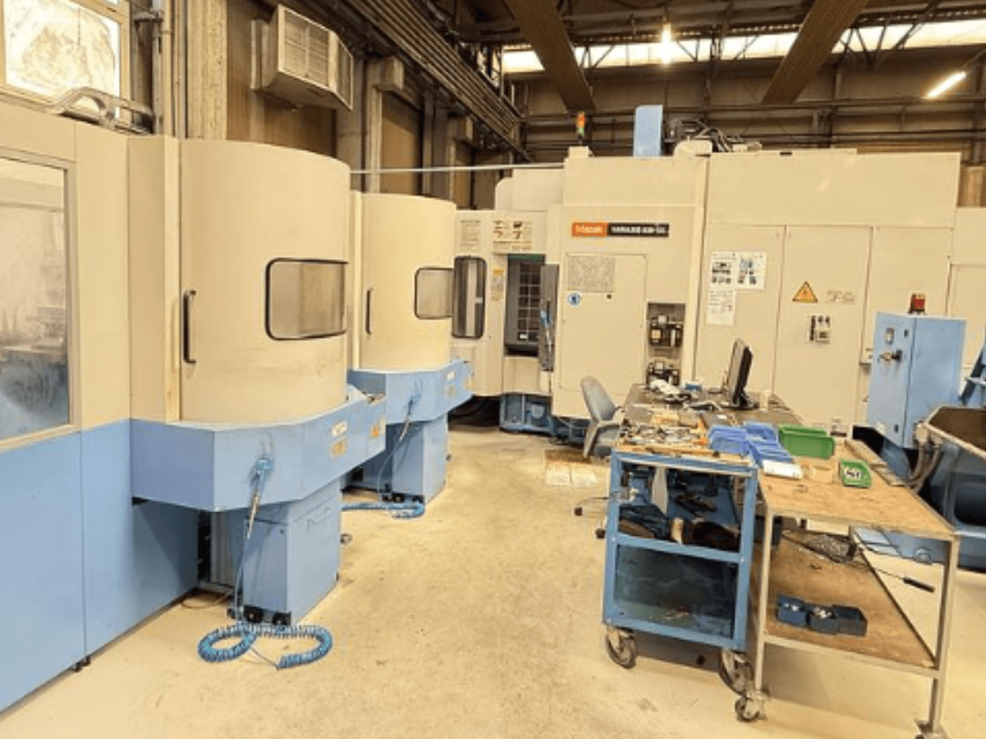 Вертикальный обрабатывающий центр Mazak Variaxis 630-5X в мастерской, вид спереди на панель управления и зону хранения инструментов.