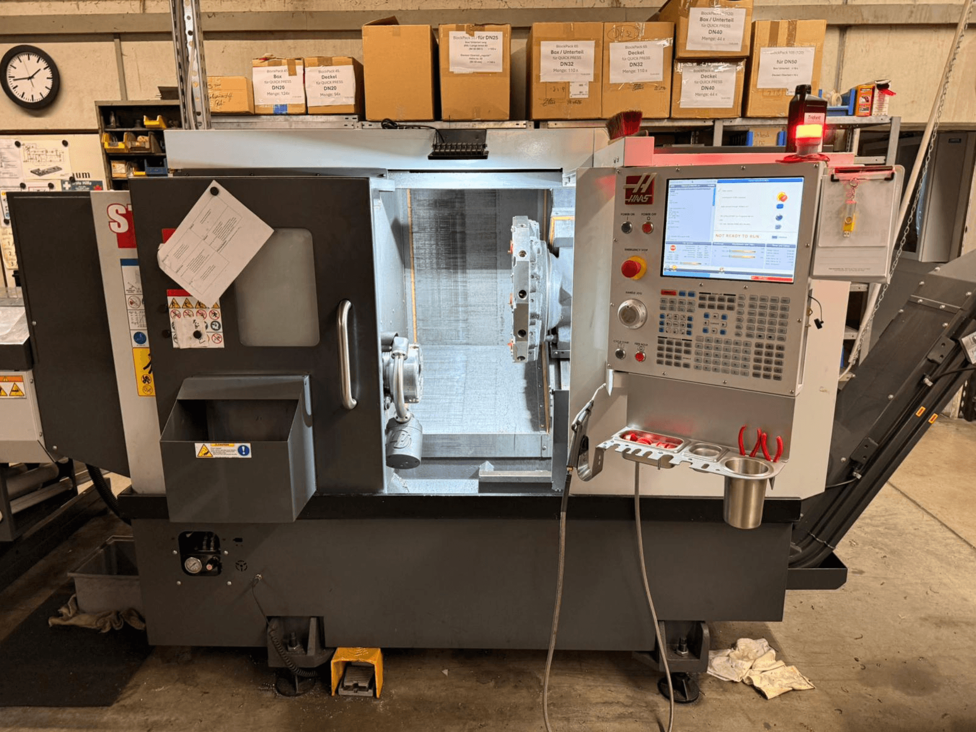 Горизонтальный токарный станок HAAS ST-15, показанный с боковой стороны, с цифровой панелью управления и рабочими компонентами.