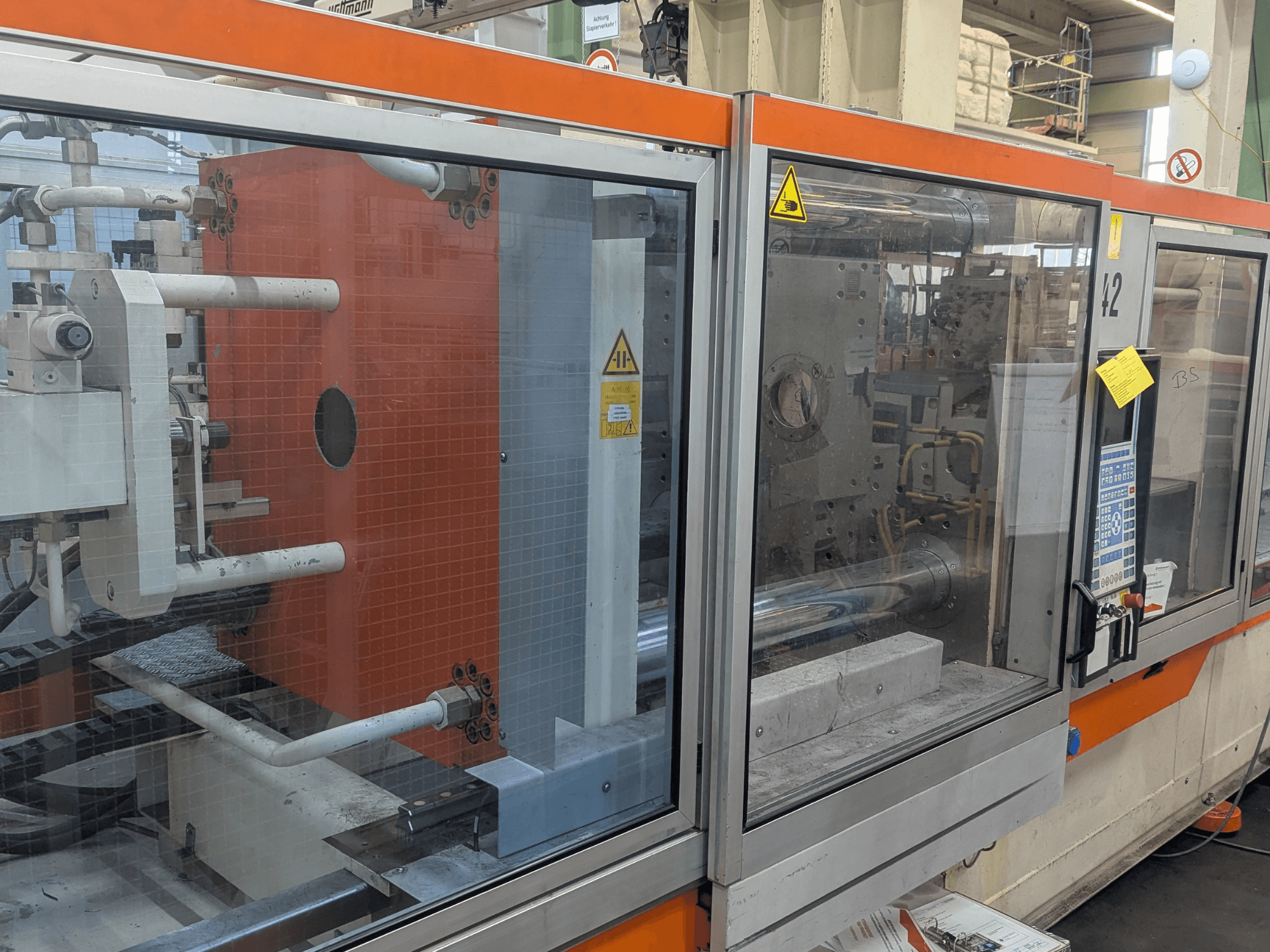 Вид спереди на гидравлическую литьевую машину DEMAG SYSTEC 80/420-310 с видимой панелью управления и компонентами оборудования.