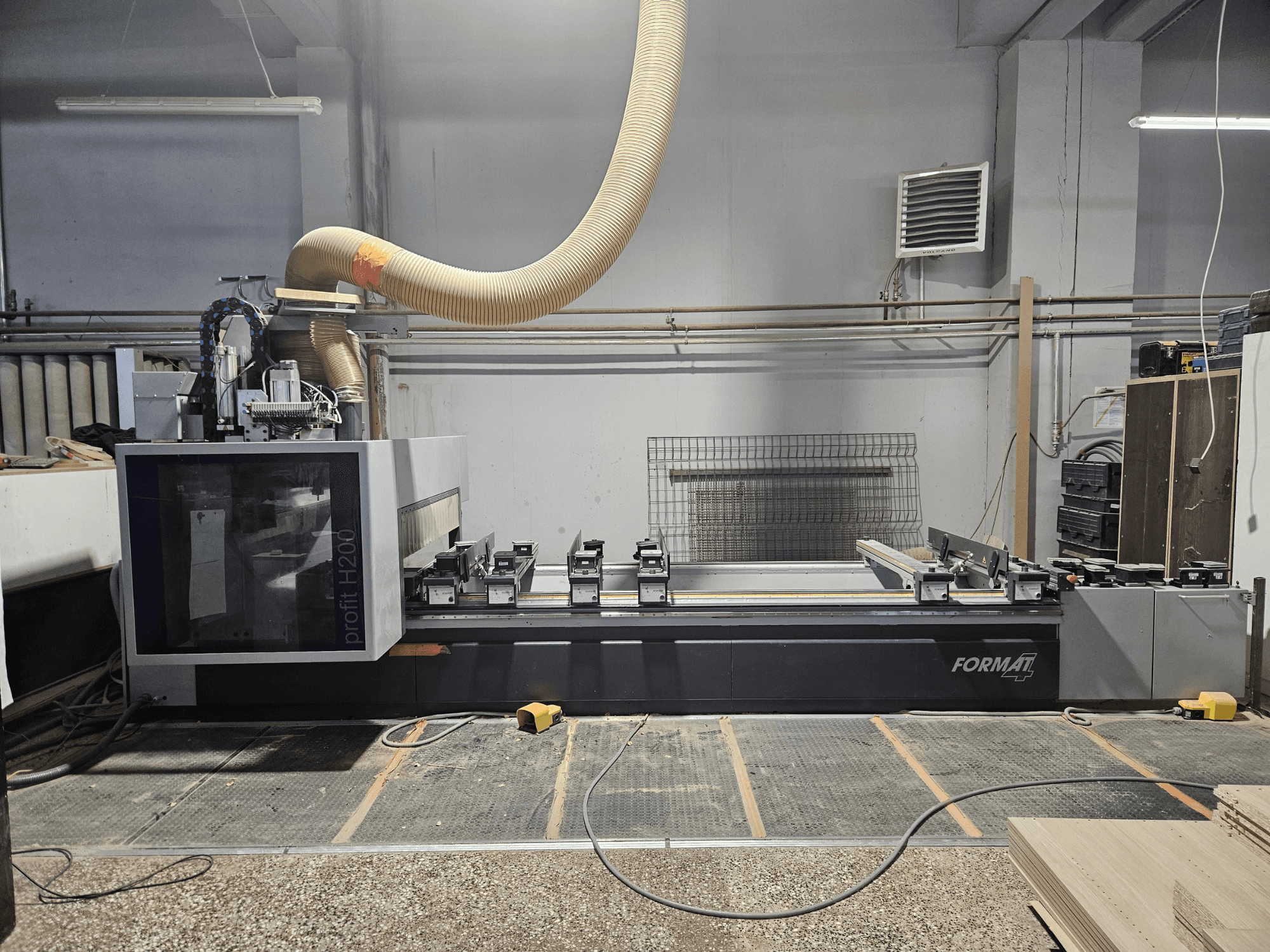 Станок с ЧПУ FORMAT profit H200 в мастерской, вид сбоку, демонстрирующий рабочую поверхность и систему пылеудаления.