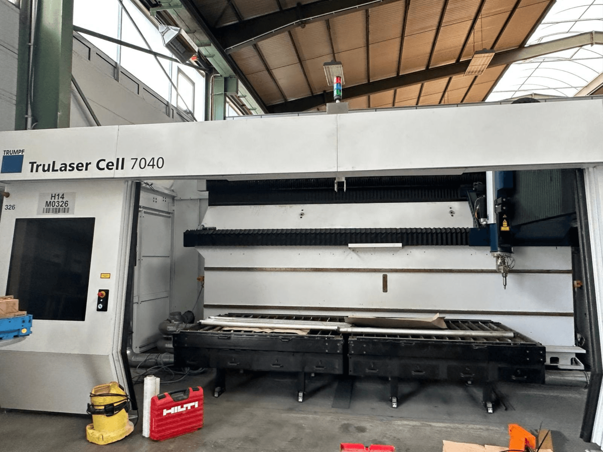Станок для лазерной резки CO2 TRUMPF TruLaser Cell 7040 в виде спереди, на котором видны панель управления и зона резки.