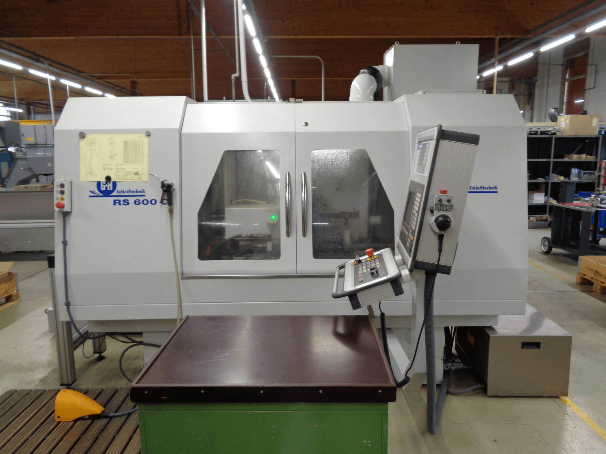 Цилиндрический шлифовальный станок GEIBEL & HOTZ RS 600 C, вид спереди на панель управления и рабочий стол в заводских условиях.