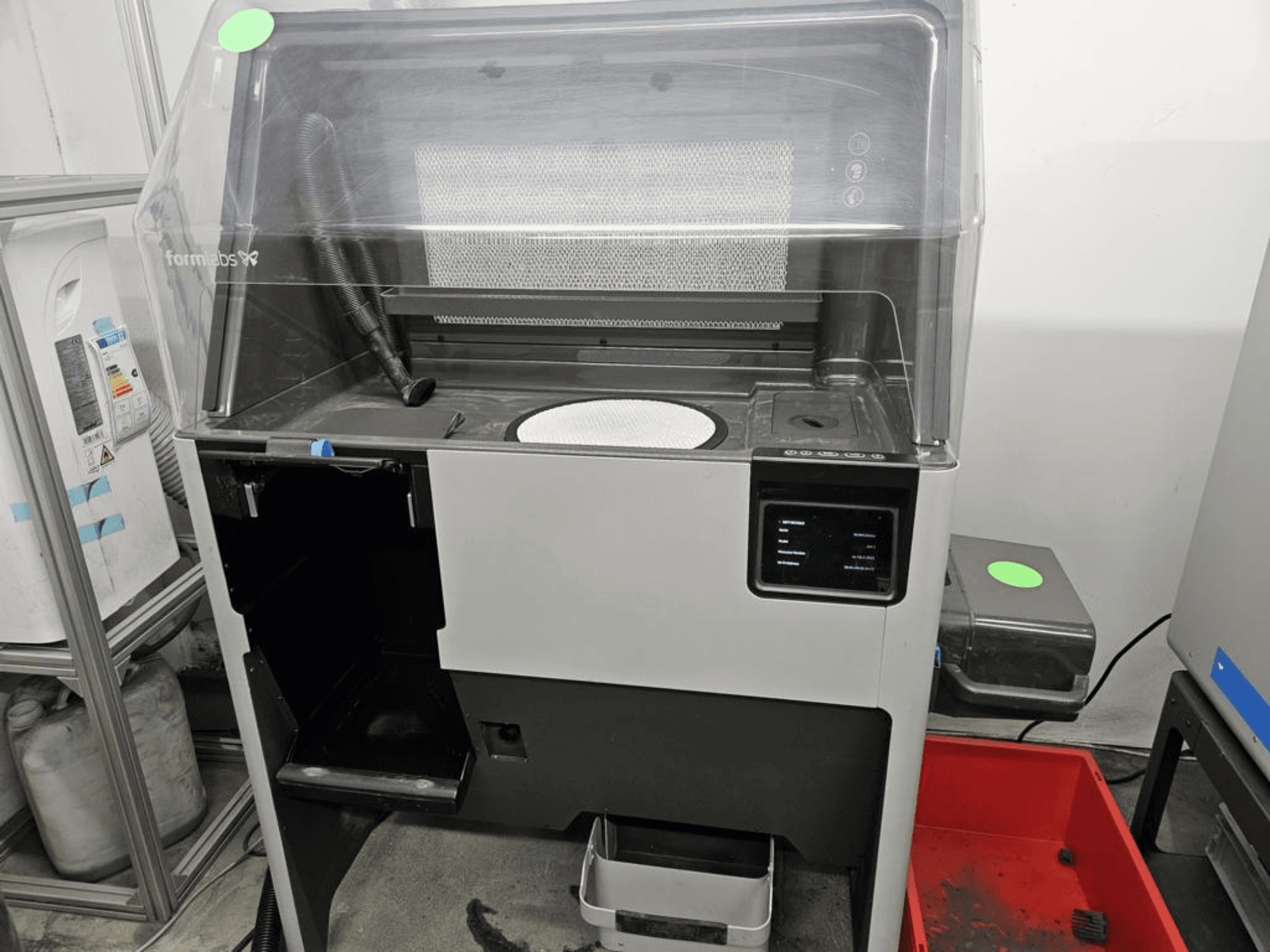 3D-принтер для печати из пластика FORMLABS Fuse 1 + 30 Вт, вид спереди с сенсорной панелью управления и съемным лотком.