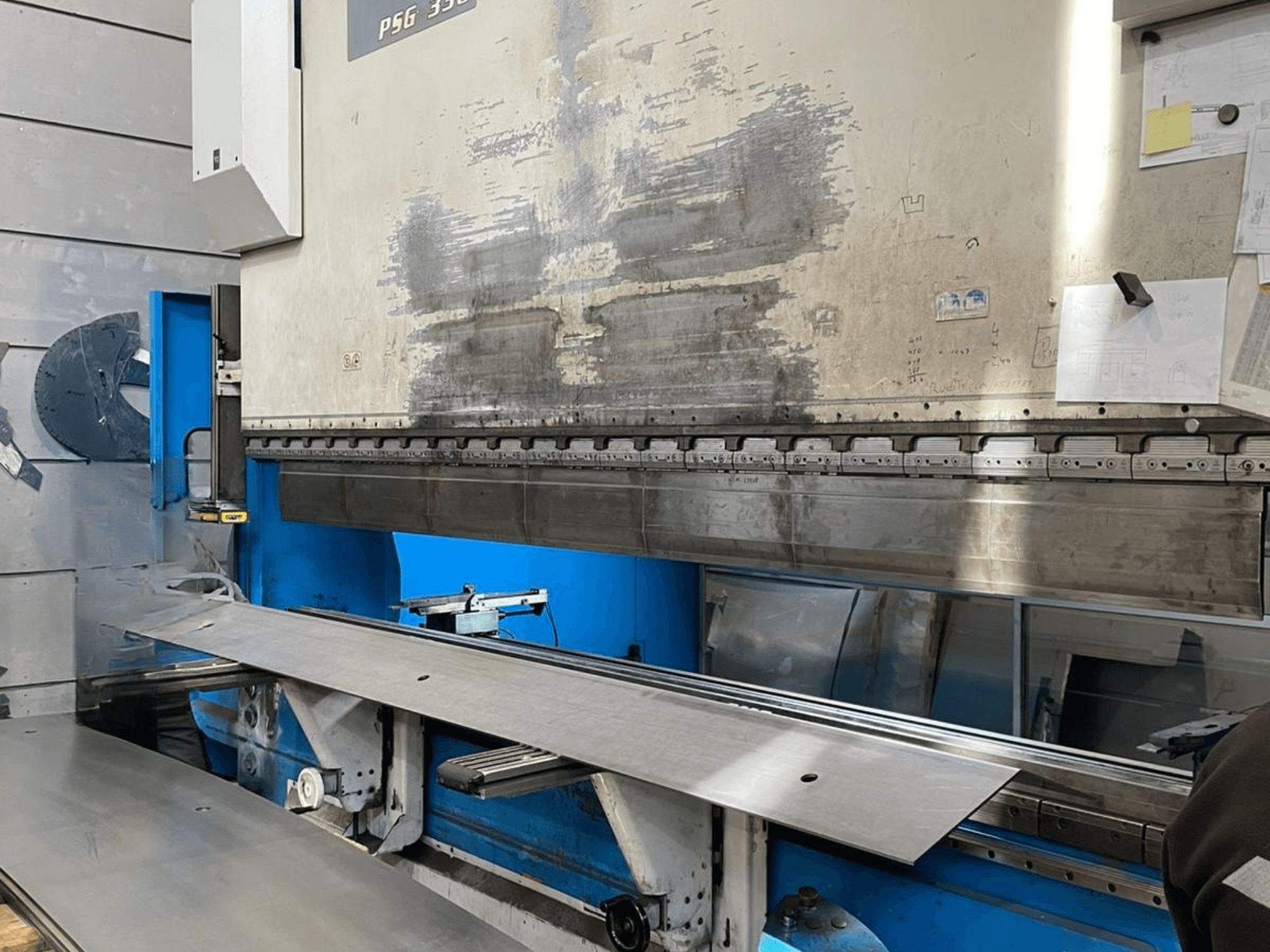 Листогибочный пресс GASPARINI PSG 330/4000 Variante C в мастерской, зона гибки с металлическим листом и органы управления оборудованием.